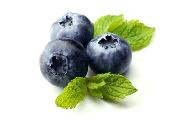 Fresh blueberries with mint leaves isolated on white