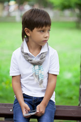 Fashionable little boy outdoor at the nice summer day