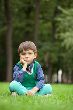 Fashionable little boy outdoor at the nice summer day