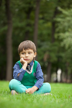 Fashionable little boy outdoor at the nice summer day