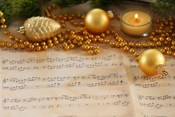 Fototapeta na wymiar Christmas decorations on music sheets, closeup
