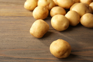 New potatoes on wooden background