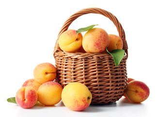 Ripe apricots in wicker basket isolated on white