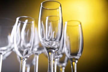 Empty champagne glasses on yellow background