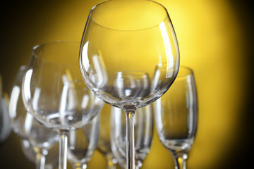 Empty wine glasses on yellow background