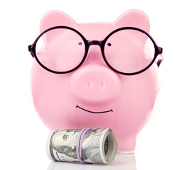 Piggy bank in glasses with dollars isolated on white