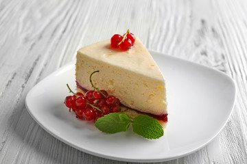 Delicious cheesecake with berries on table close up