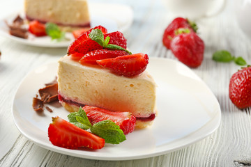 Delicious cheesecake with berries on table close up