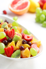 Fresh fruit salad on white wooden table
