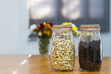 Cashew nuts and raisins in jars.