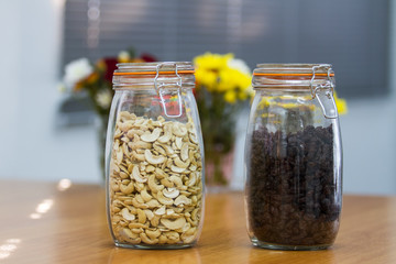 Cashew nuts and raisins in jars.