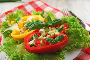 Fresh green salad in pepper on table close up