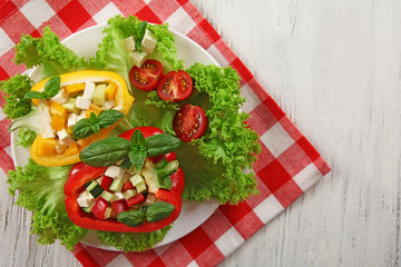 Fresh green salad in pepper on table close up
