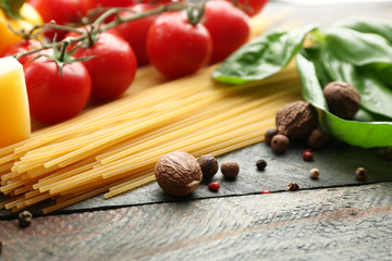 Pasta spaghetti with tomatoes, cheese and basil on rustic wooden  background