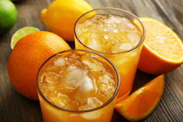 Glasses of orange juice on wooden table, closeup