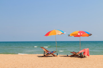 Obraz na płótnie Canvas Beach chair and umbrella on sand beach