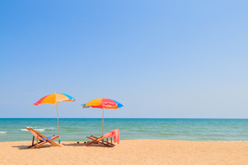 Fototapeta na wymiar Beach chair and umbrella on sand beach