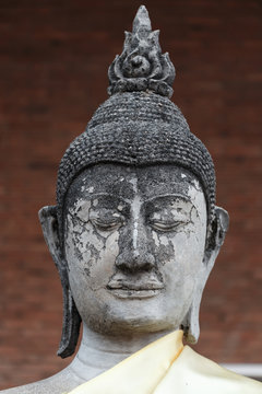 Close-up head of old buddha statue in Thailand