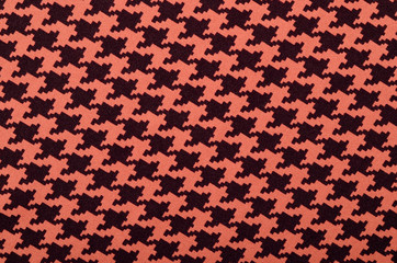 Orange and black houndstooth pattern.  Dogstooth check design as background.