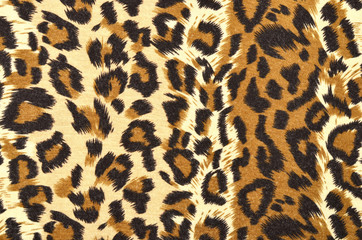 Brown leopard fur pattern. Spotted animal print as background.