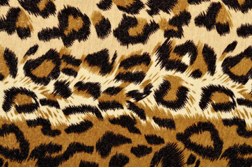 Brown leopard fur pattern. Spotted animal print as background.