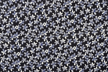 Small floral pattern. Blue and white flowers print on dark blue background.