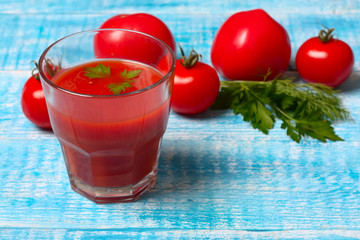 Glass of tasty tomato juice and fresh tomatoes