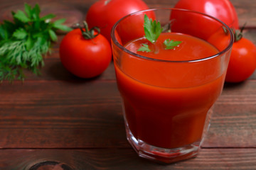 Glass of tasty tomato juice and fresh tomatoes