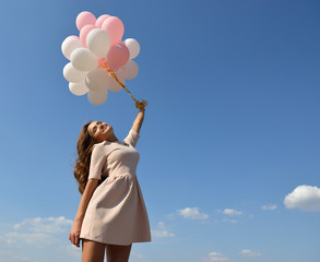 Obraz na płótnie Canvas Fashion girl with air balloons over blue sky