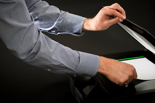 Man using scanner multifunction device.