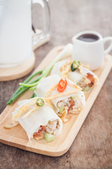 Fresh spring rolls on wooden table