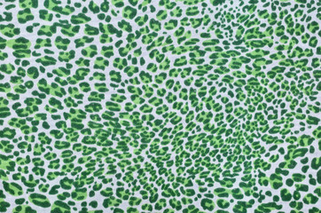 Green leopard fur pattern. Spotted animal print as background.