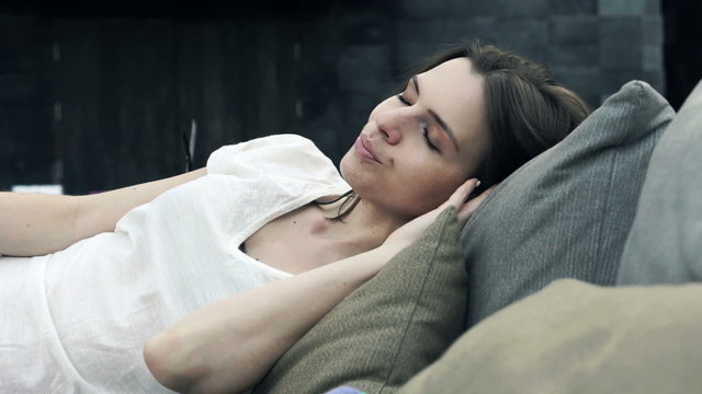 Young, pretty woman sleeping on daybed
