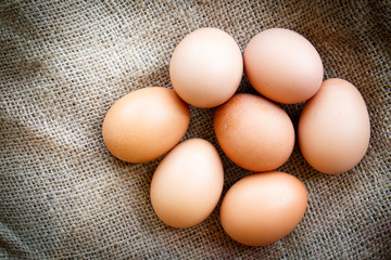 Fresh raw group of eggs put on old sack