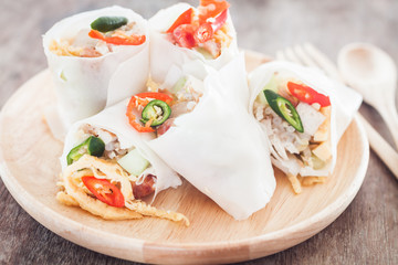 Fresh spring rolls on wooden table