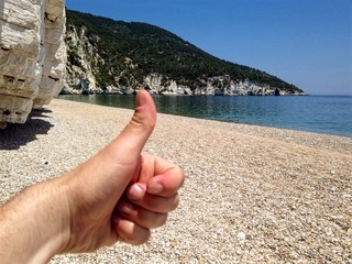 Allright hand on sunny beach