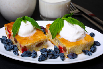 Appetizing cottage cheese casserole with berries and sour cream