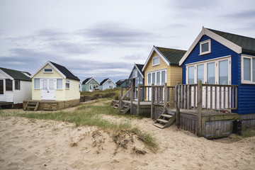 Fototapeta na wymiar Lovely beach huts on sand dunes and beach landscape