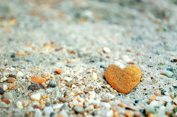 Heart shaped stone on the sand