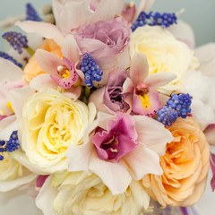 Beautiful composition with orange roses and violet orchids 
