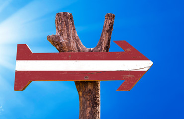 Latvia Flag wooden sign with sky background