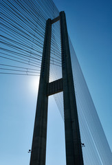 Modern bridge pylon against a blue sky