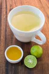honey and lemon on wooden table