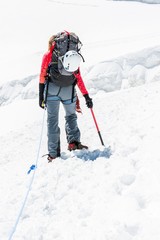 Fototapeta na wymiar Female mountaineer ascending a glacier.