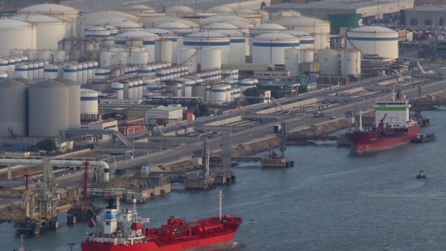 Ship anchored in the bulk liquid terminal port of Barcelona while passing another boat load.Time Lapse