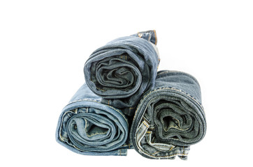 roll blue denim jeans arranged in stack