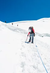 Fotobehang Female mountaineer ascending a glacier. © anzebizjan