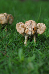 Elephant rattan handmade standing through tall grass