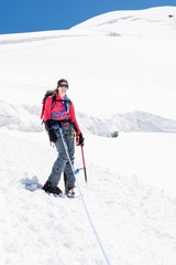 Fototapeta na wymiar Female alpinist standing on glacier.