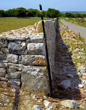 Restore drywall with stones wall in focus in the countryside of Apulia